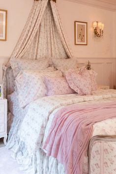 a bed with pink and white bedspread in a bedroom