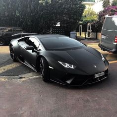 a black sports car parked in a parking lot