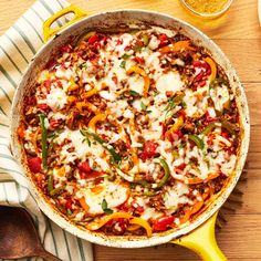 a pizza in a pan with cheese and peppers