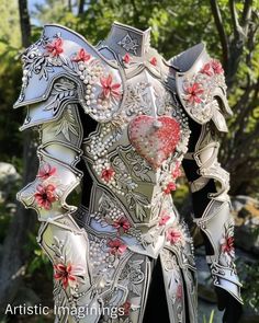 an elaborately designed armor with flowers and pearls on the chest is displayed in front of some trees