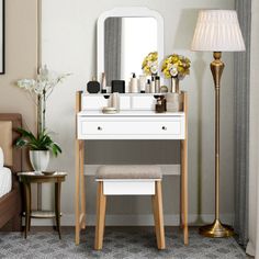 a bedroom with a vanity, stool and mirror