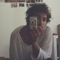 a young man taking a selfie with his camera