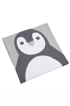 a grey and white blanket with a penguin on it