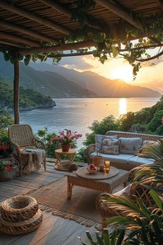 the sun is setting over an outdoor patio with wicker furniture and flowers on it