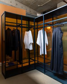 an open room with clothes hanging in it