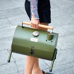 a woman carrying a green briefcase on her back