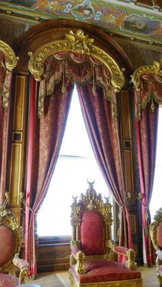 an ornately decorated room with red and gold furniture