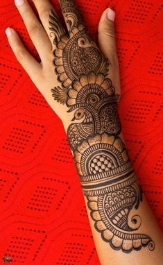 a woman's hand is decorated with hennap and intricate designs on it