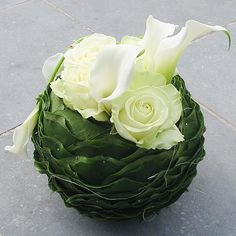 a bouquet of white flowers sitting on the ground