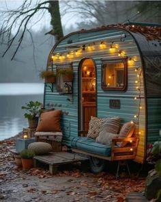 an old trailer is decorated with fairy lights