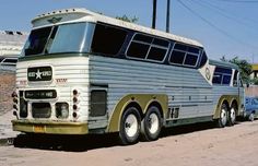 an old bus is parked on the side of the road