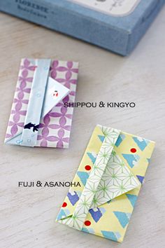 folded origami pieces on a table next to a box with the words shippu & kinyo written in it