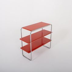 a red shelf sitting on top of a white floor