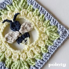 a crocheted square with two cats on it