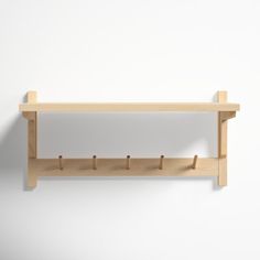 a wooden shelf with hooks attached to it