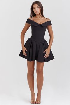 Raise your glasses to the Sabina Off-the-Shoulder Mini Dress! Soft poly shapes this stunning little black dress that has an elegant off the shoulder collar and a fitted bodice with waist cinching corset boning. A high waist tops a dance floor-ready skater mini skirt. It zips to the back for easy on and looks ultra feminine styled with dainty high heels. 100% Polyester. Unlined. Runs true to size. Hand Wash Cold. Do Not Bleach. Line Dry. Iron Low Heat. Origin China. ** Color may vary due to light Ultra Feminine Style, Mini Dress Elegant, How To Fold Sleeves, Formal Wear Dresses, Shoulder Sling, Black Off Shoulder, Corset Mini Dress, Black Corset, Mini Cocktail Dress