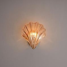 a scallop shaped light fixture on a wall