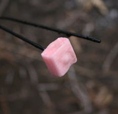 two marshmallows hanging from a string with the caption, have you ever tried roasted starburst over a campfire? it's amazing