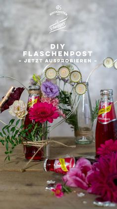 flowers in vases and bottles on a table with the words diy flaschenpost