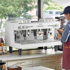 a man standing in front of a coffee machine