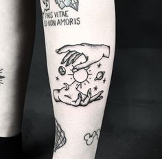 tattoos on the legs of two people holding hands