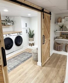 an open door leading to a washer and dryer in a room with wooden floors