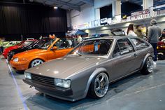 several cars are on display at an auto show