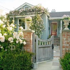 a blue house with white flowers on the front door