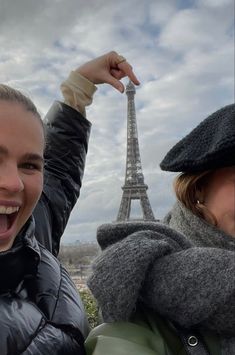 two people taking a selfie with the eiffel tower in the back ground