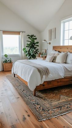 a large bed sitting in the middle of a bedroom on top of a wooden floor