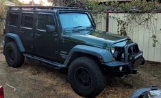 a black jeep parked in front of a house