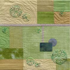 two quilts with green and yellow designs on them, one has a blue circle in the center