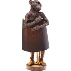 a lamp that has a monkey on it with a brown shade over the top of it