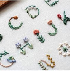 the letters are made up of small flowers and leaves
