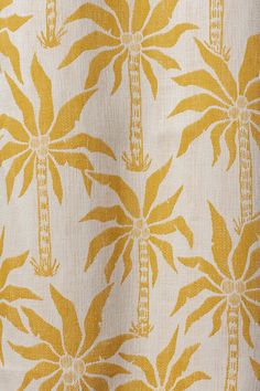 a yellow and white fabric with palm trees on it