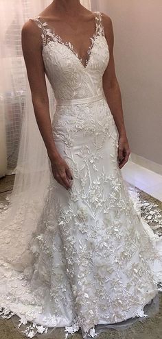 a woman in a white wedding dress posing for the camera