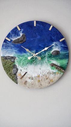 a clock that is on the side of a wall with water and rocks in it