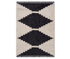 a black and white rug with fringes on the bottom, in different shapes and sizes