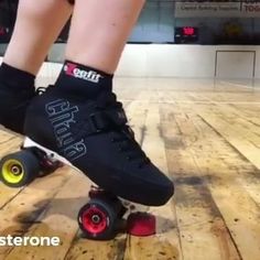 a person riding a skateboard on top of a wooden floor