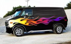 a black van with flames painted on it