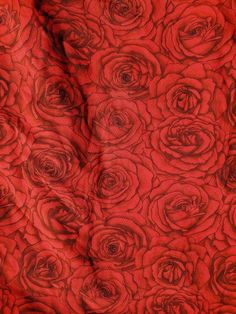 an image of red fabric with roses on it