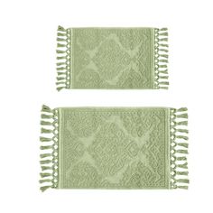 two green place mats with fringes on them