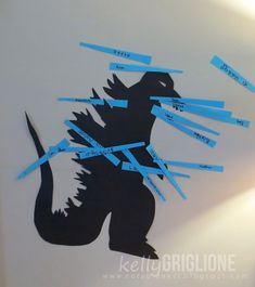 an image of a godzilla with blue tape on it