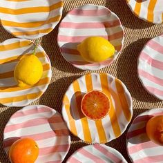 several plates with oranges and lemons on them are arranged in a grid pattern