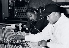 an old photo of two people working in a recording studio