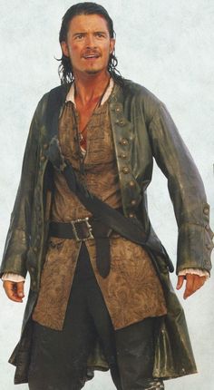 a man dressed in pirate clothing standing with his hands on his hips