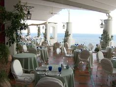 an outdoor dining area with tables and chairs