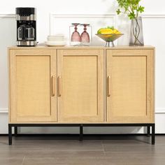 a sideboard with two doors and some plates on it