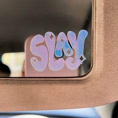 the word stay written in pink and blue spray paint on a car's side mirror