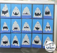 some blue boxes with white sharks painted on them and the words cut out in spanish